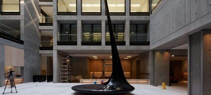 Angel Euston Installing the Ian McChesney 20 metre tall carbon feature bench in the Atrium of Angel Building